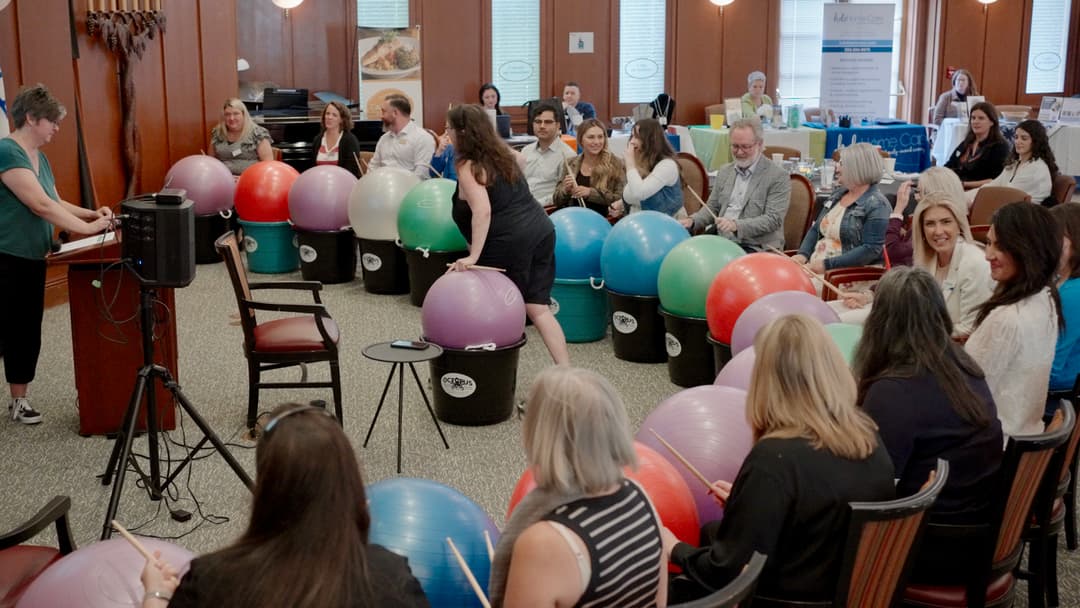 OSRAA members in a team-building exercise with exercise balls at a conference