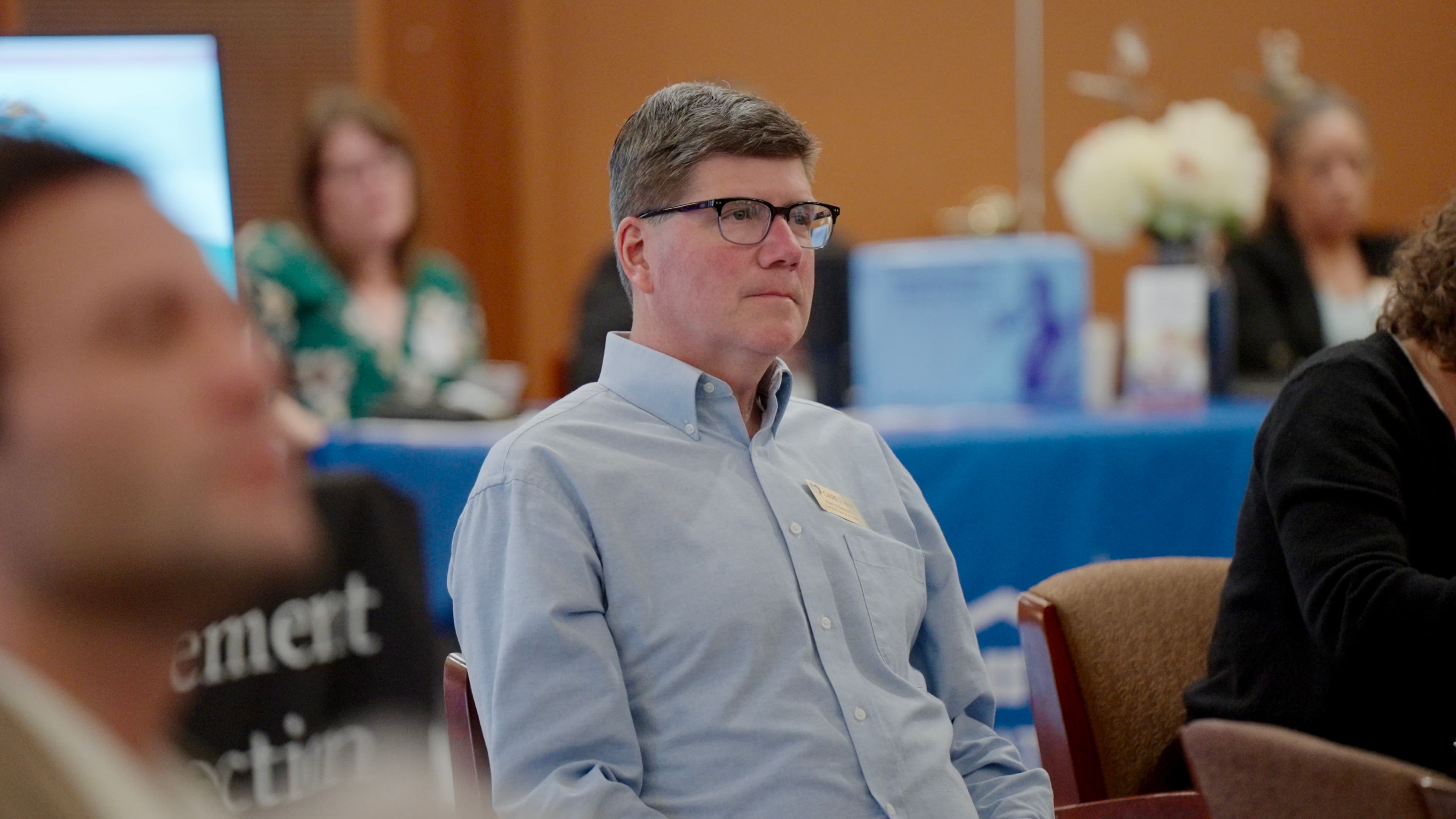 Attendee listening attentively during a conference session